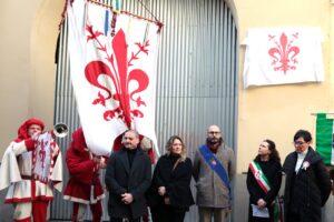 rappresentanti delle istituzioni con gonfalone comune firenze davanti alla targa coperta da drappo